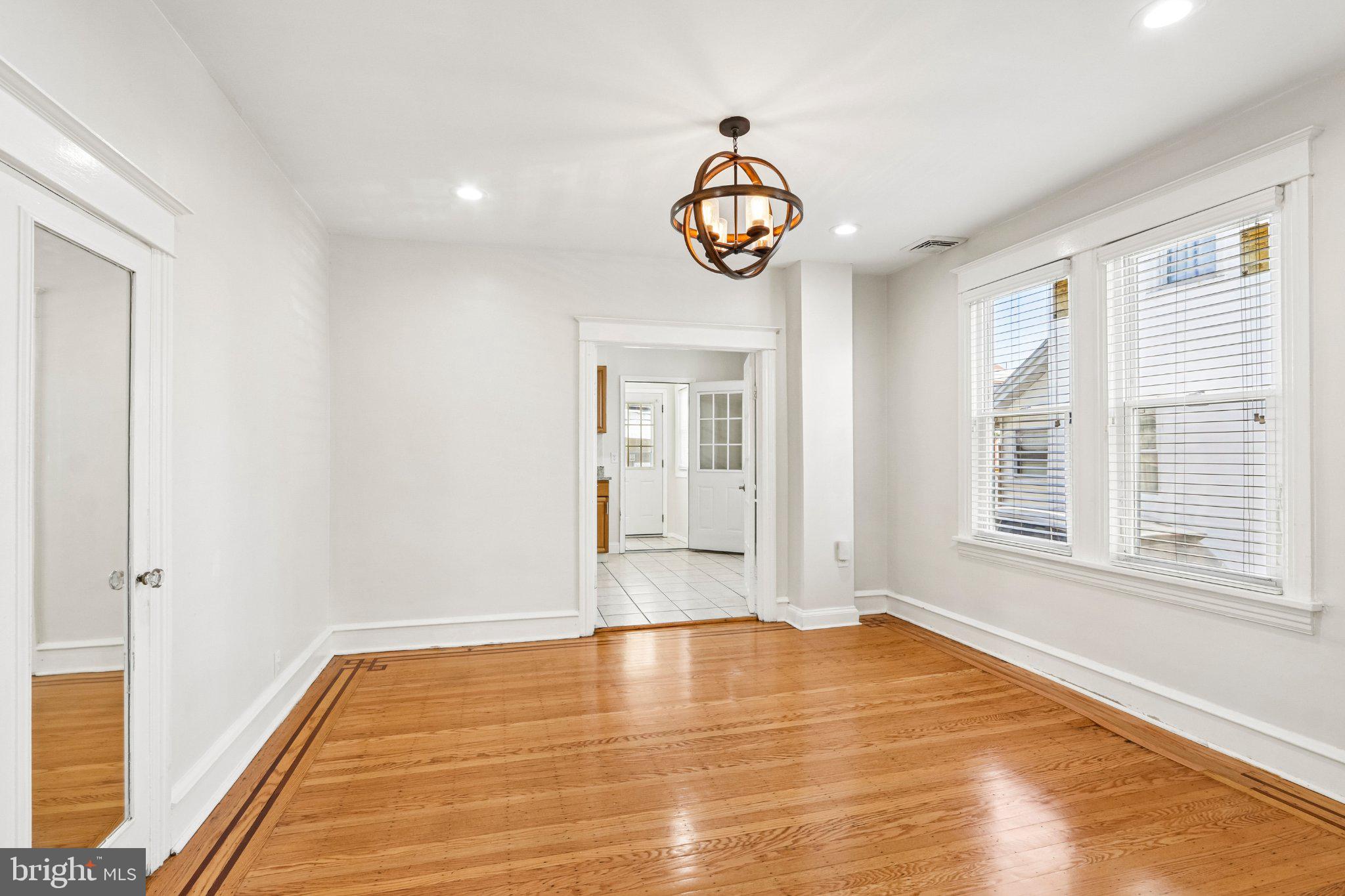 7407 Rogers Avenue Upper Darby, PA 19082 - Photo 11 of 50 a view of an empty room with wooden floor and windows