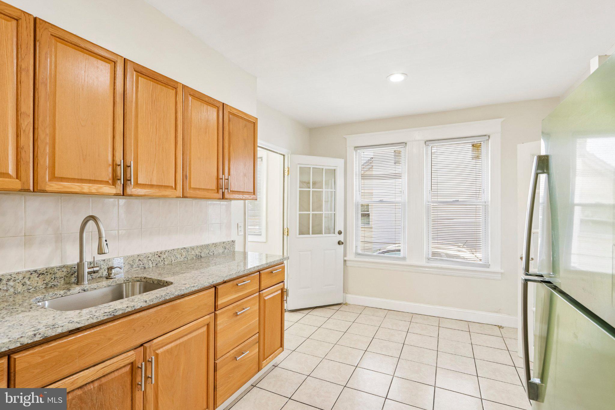 7407 Rogers Avenue Upper Darby, PA 19082 - Photo 15 of 50 a kitchen with a sink a refrigerator and cabinets