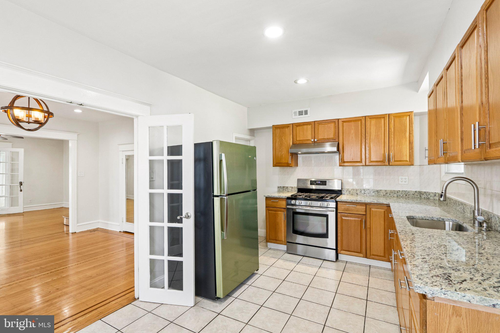 7407 Rogers Avenue Upper Darby, PA 19082 - Photo 18 of 50 a kitchen with granite countertop a refrigerator and a sink