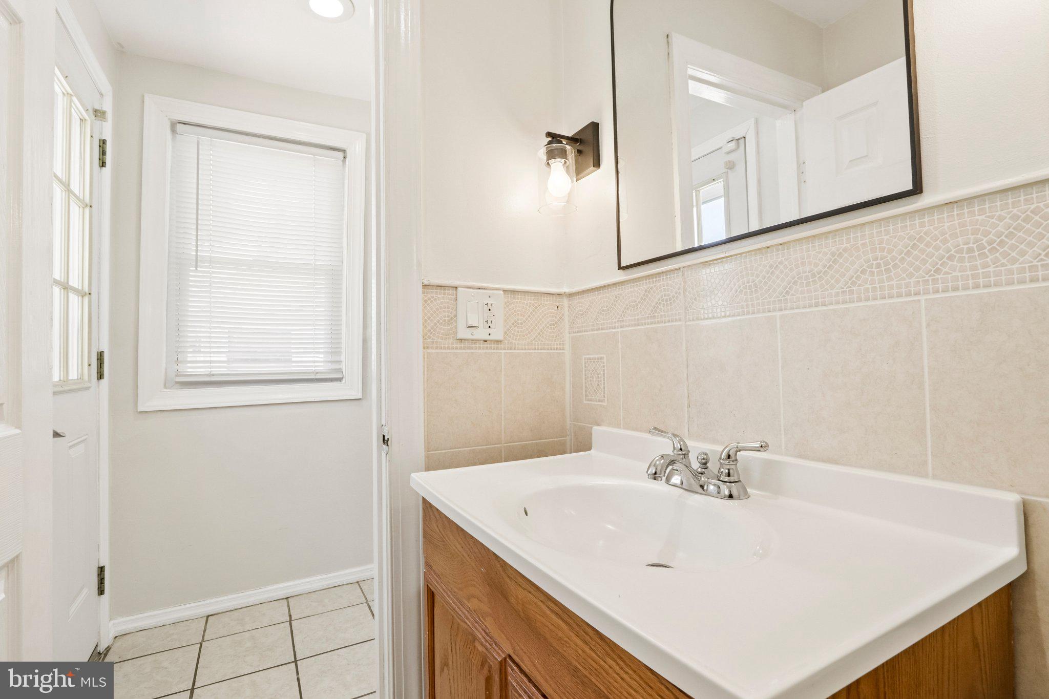 7407 Rogers Avenue Upper Darby, PA 19082 - Photo 22 of 50 a bathroom with a sink and a mirror