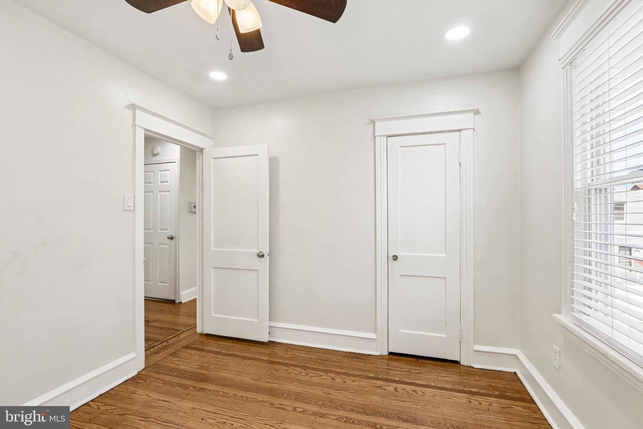 7407 Rogers Avenue Upper Darby, PA 19082 - Photo 28 of 50 an empty room with wooden floor cabinet and windows