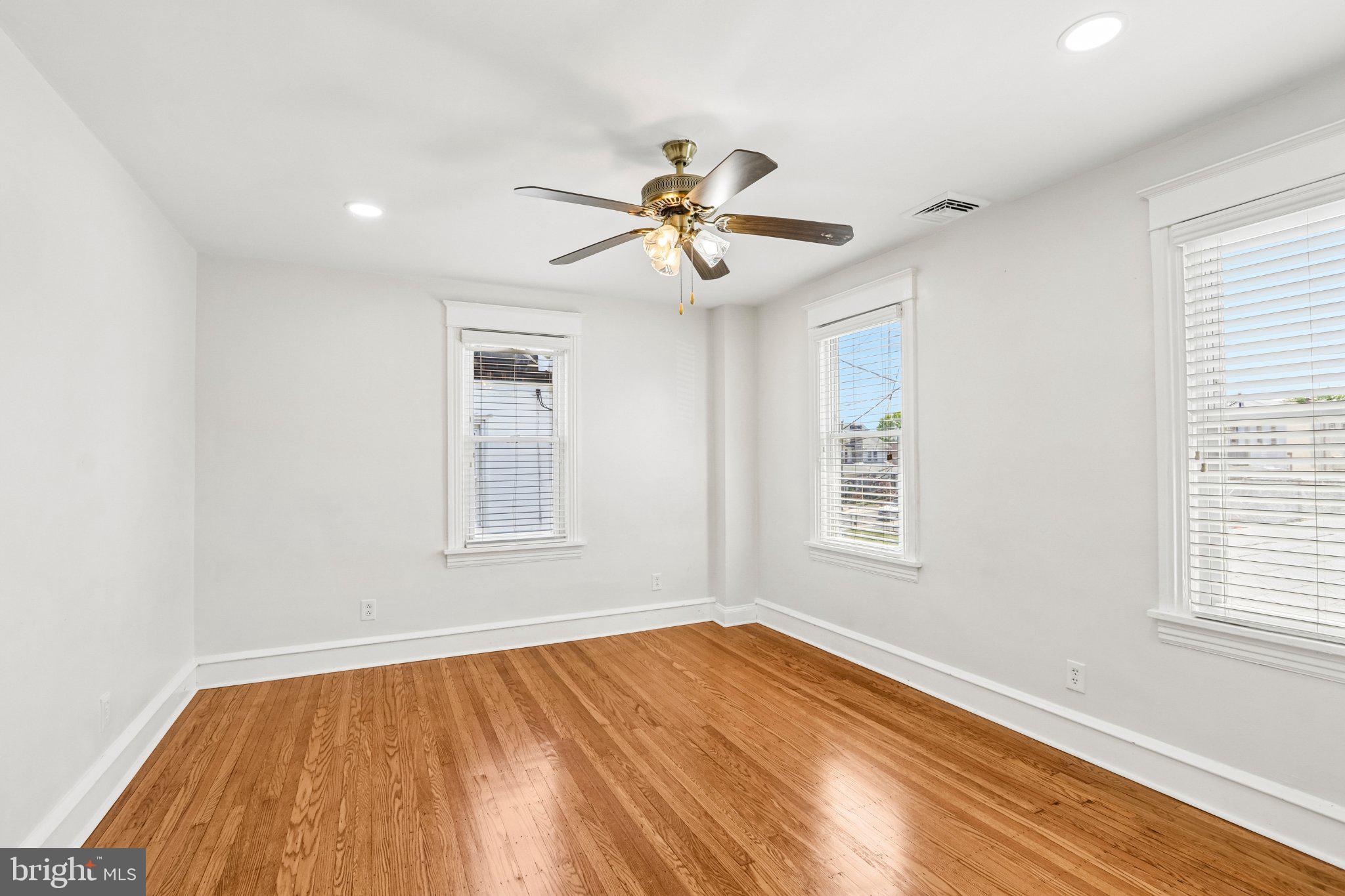 7407 Rogers Avenue Upper Darby, PA 19082 - Photo 29 of 50 a view of empty room with wooden floor and fan