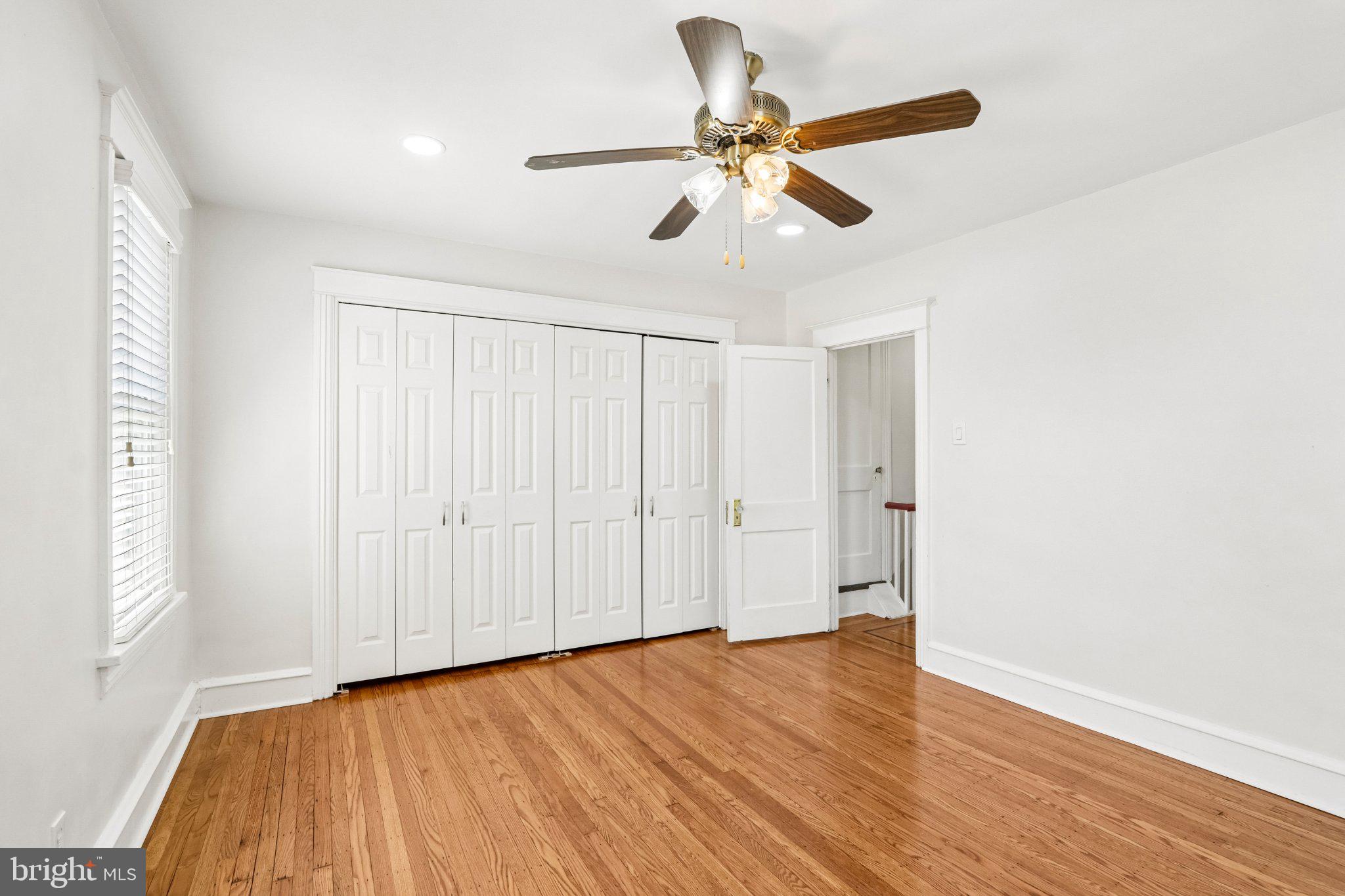 7407 Rogers Avenue Upper Darby, PA 19082 - Photo 30 of 50 an empty room with wooden floor fan and windows
