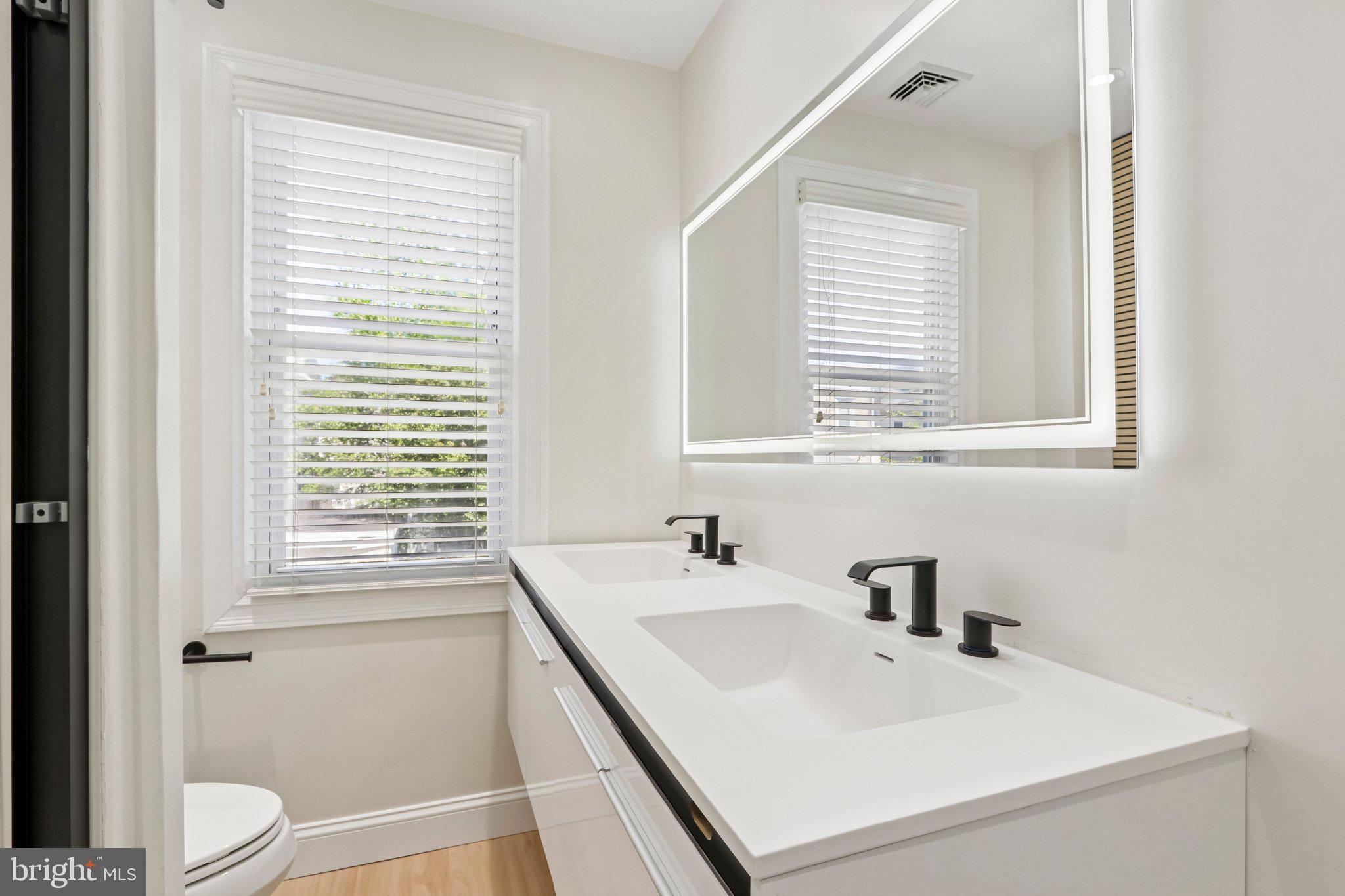 7407 Rogers Avenue Upper Darby, PA 19082 - Photo 32 of 50 a bathroom with a sink a toilet and a window