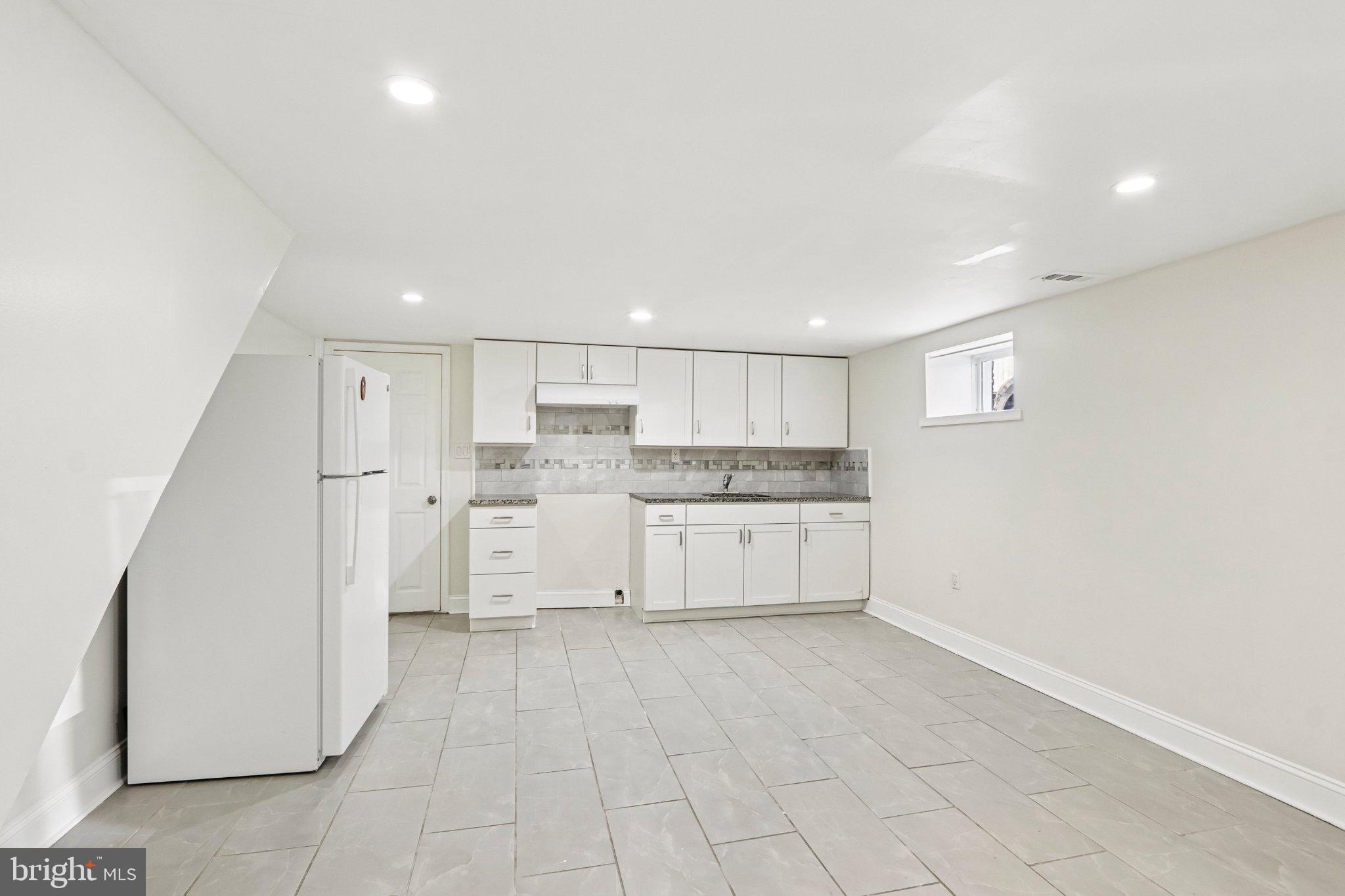 7407 Rogers Avenue Upper Darby, PA 19082 - Photo 39 of 50 a large white kitchen with white cabinets and white appliances