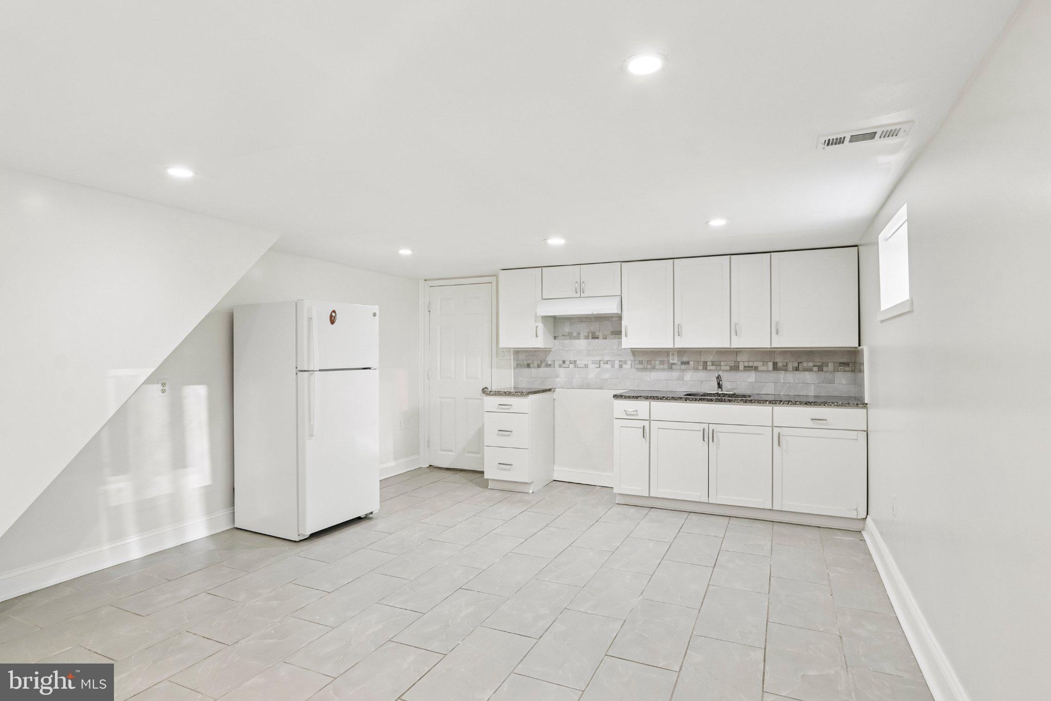 7407 Rogers Avenue Upper Darby, PA 19082 - Photo 40 of 50 a kitchen with white cabinets stainless steel appliances and a sink