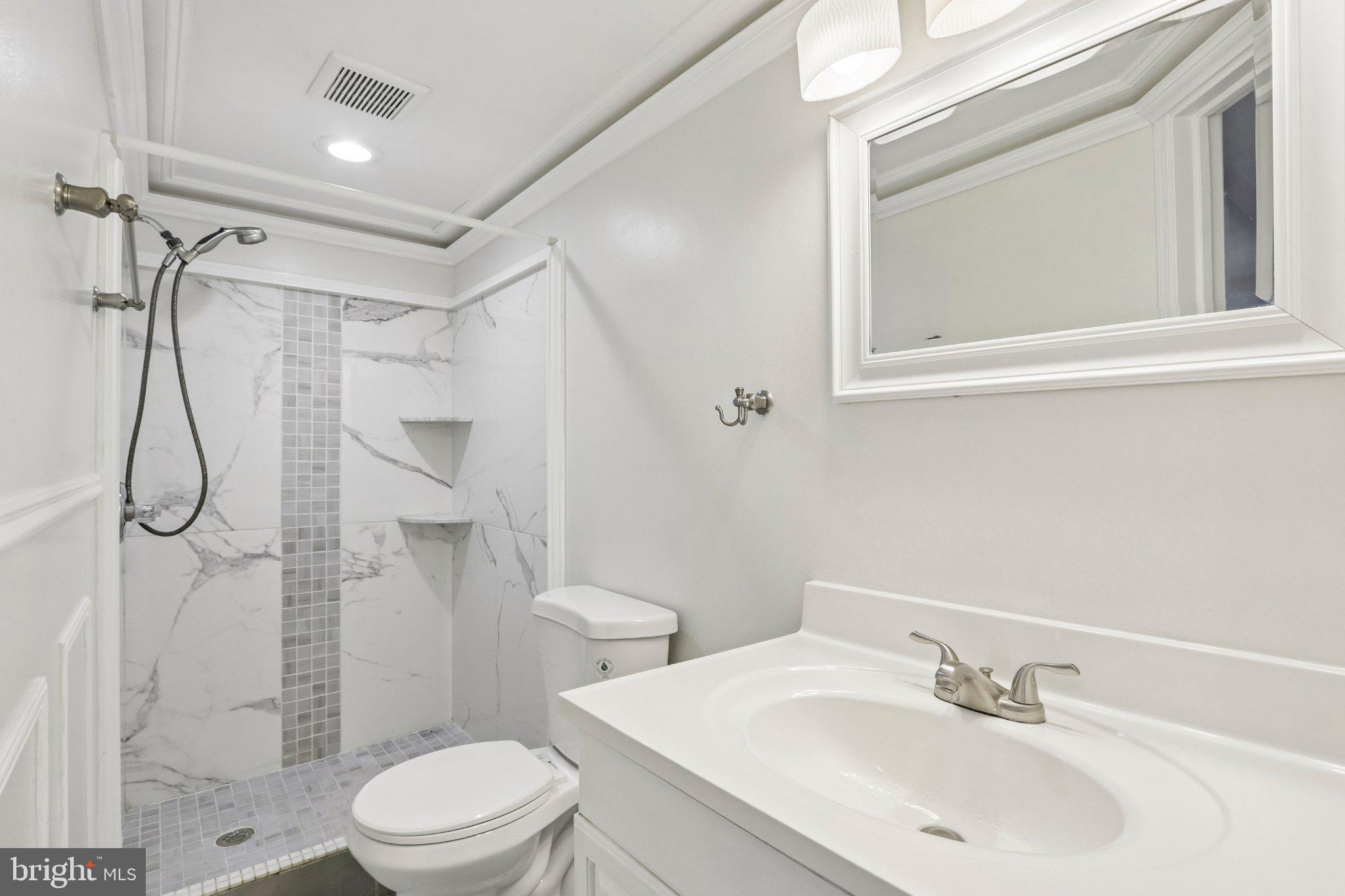7407 Rogers Avenue Upper Darby, PA 19082 - Photo 44 of 50 a bathroom with a sink toilet and shower