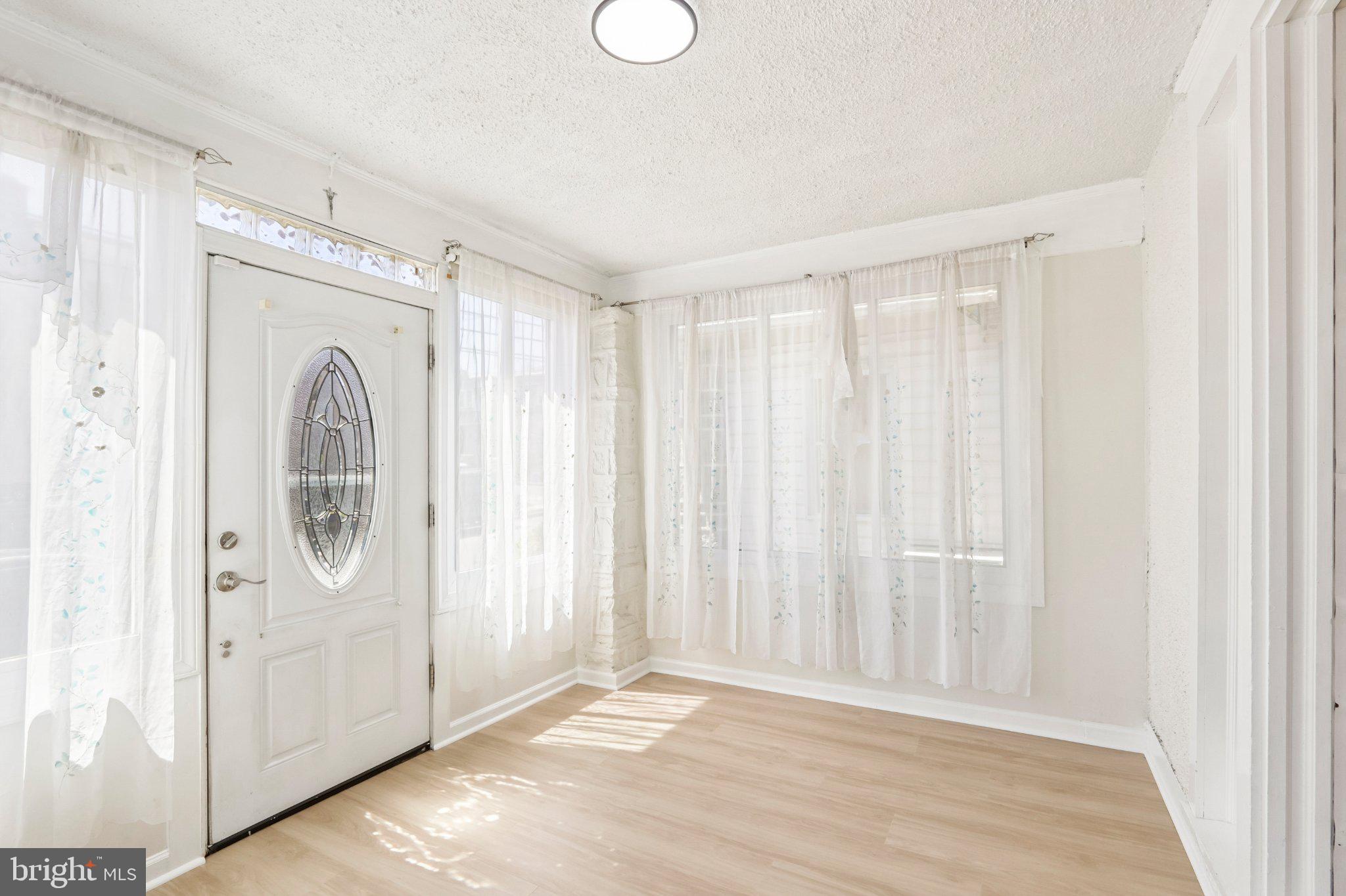 7407 Rogers Avenue Upper Darby, PA 19082 - Photo 6 of 50 a view of a livingroom with wooden floor and entryway