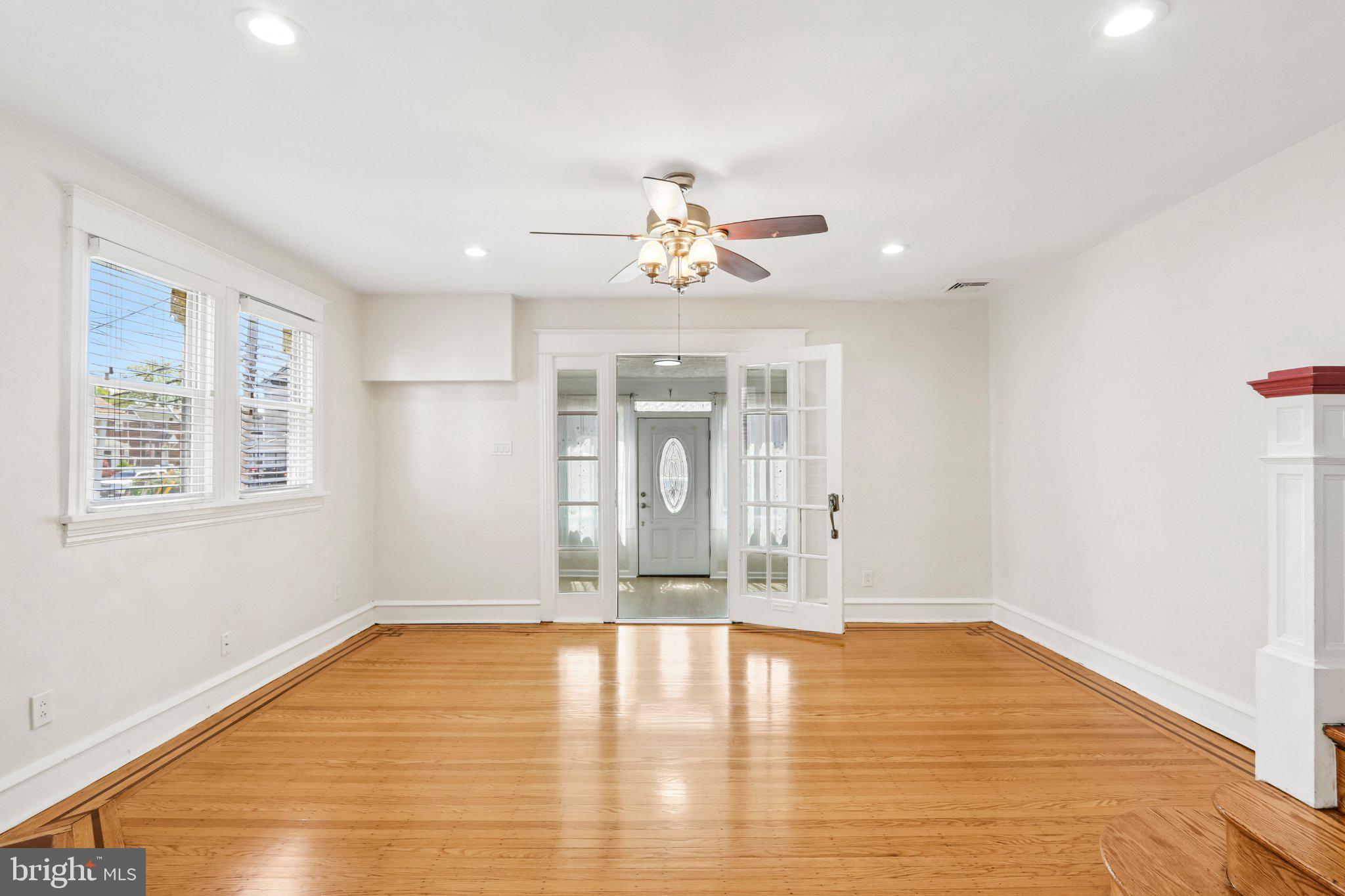 7407 Rogers Avenue Upper Darby, PA 19082 - Photo 10 of 50 a view of an empty room with window and wooden floor