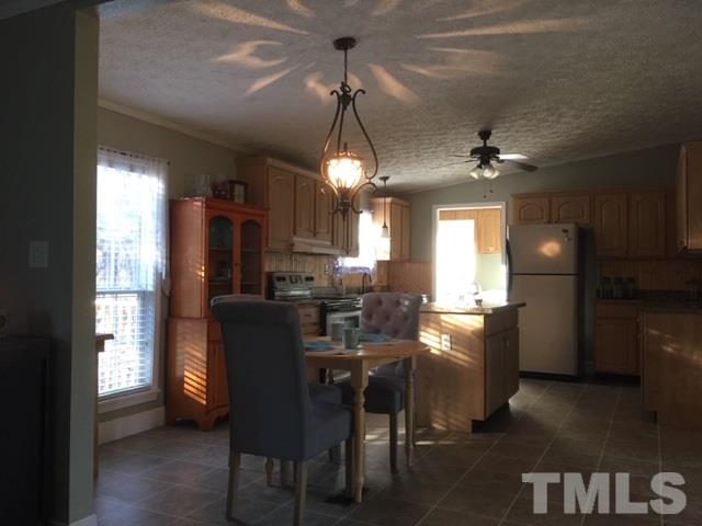 210 Enos Slaughter Road Roxboro, NC 27574 - Photo 3 of 15 a view of a dining room with furniture window and wooden floor