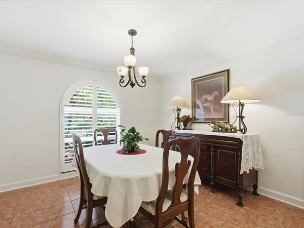 a view of a dining room with furniture and chandelier