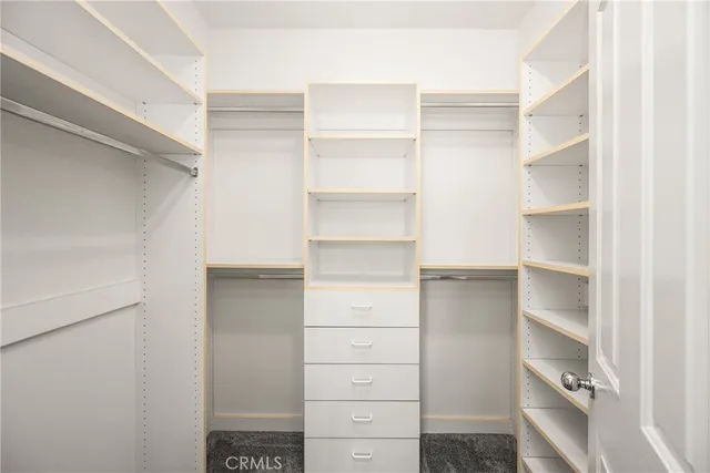 a bedroom with a bed and a potted plant