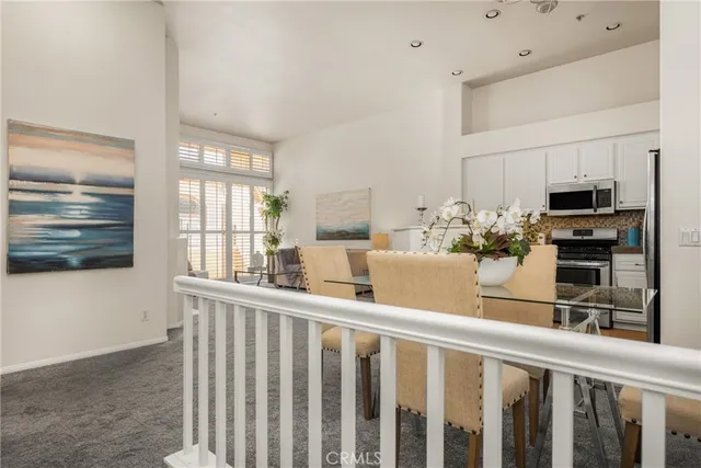 a kitchen with stainless steel appliances kitchen island granite countertop a refrigerator and cabinets
