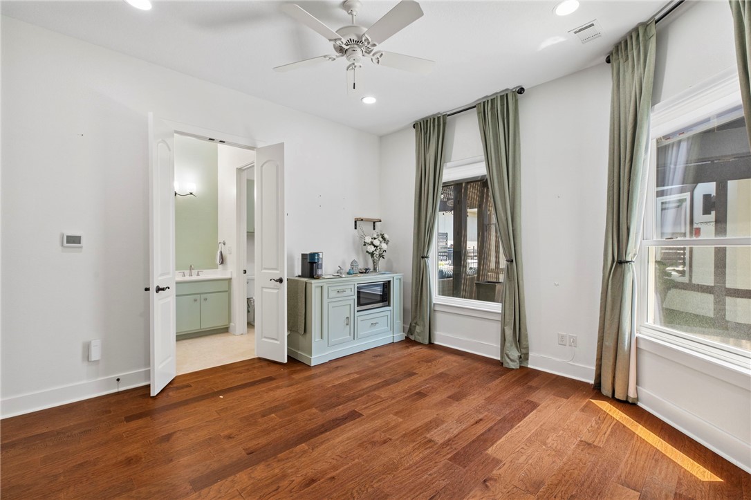 2833 Persimmon Ridge Court Bryan, TX 77807 - Photo 13 of 50 a bedroom with a bed and a flat screen tv