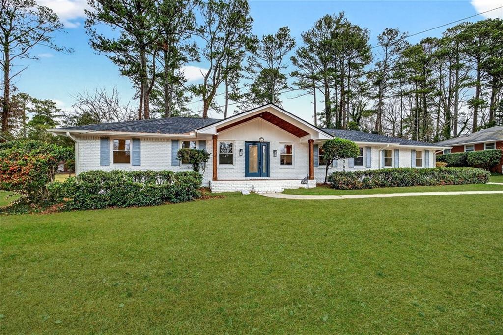 a front view of a house with a garden
