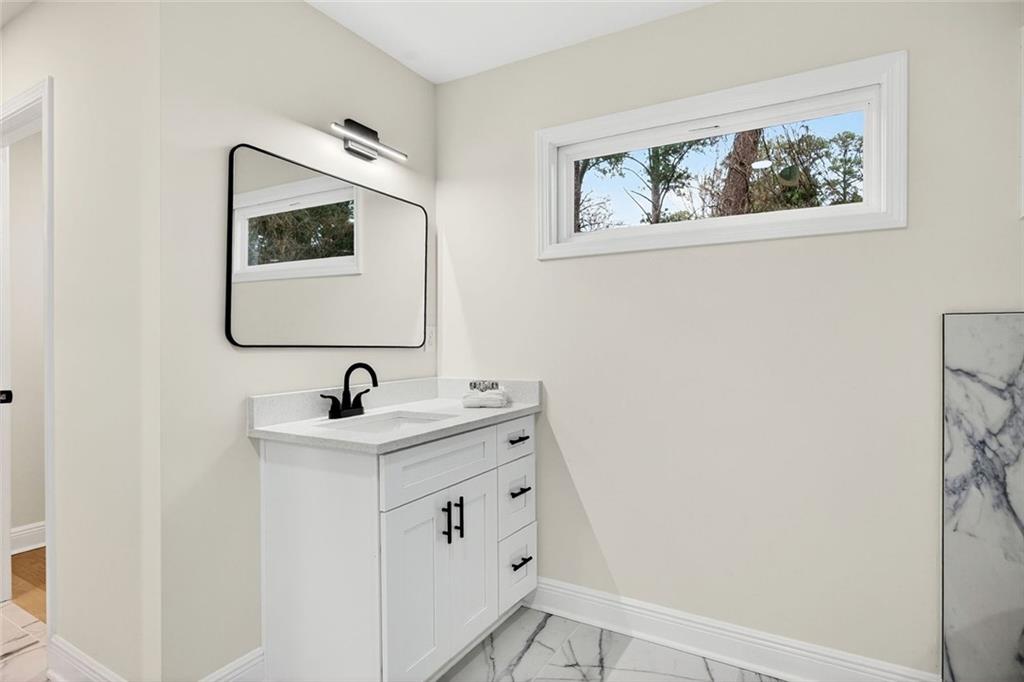 3365 Ardley Road Southwest Atlanta, GA 30311 - Photo 18 of 34 a bathroom with a toilet sink and mirror