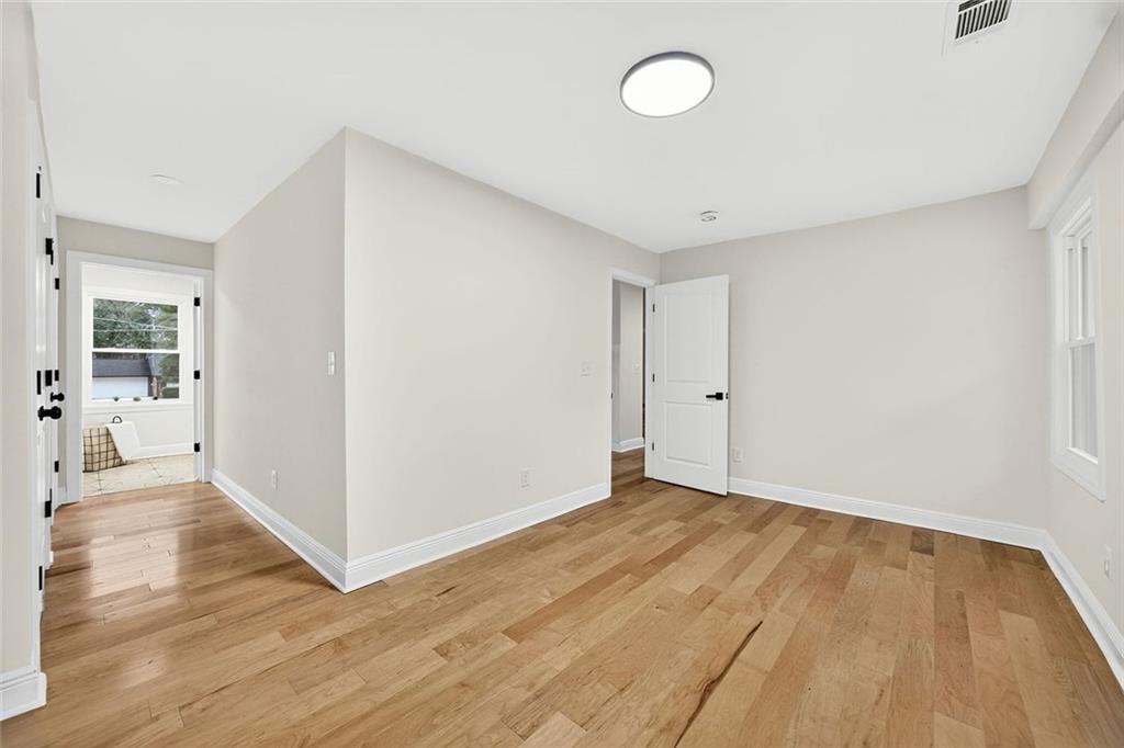 3365 Ardley Road Southwest Atlanta, GA 30311 - Photo 19 of 34 a view of an empty room with wooden floor and a window