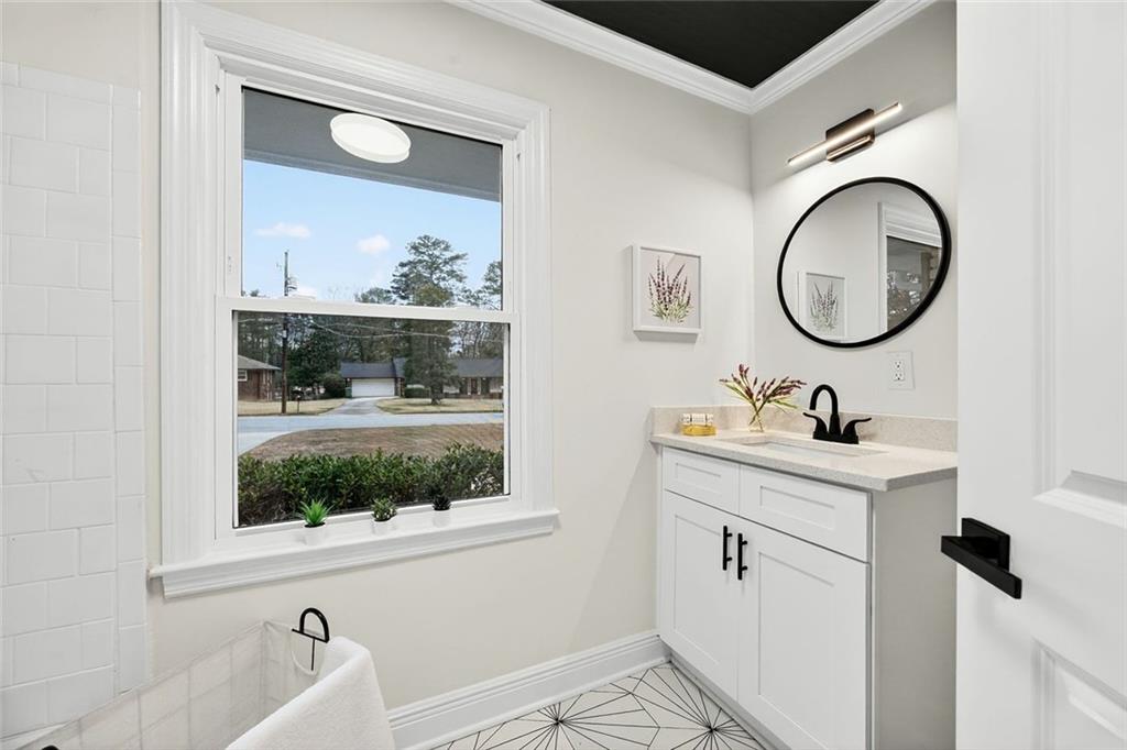 3365 Ardley Road Southwest Atlanta, GA 30311 - Photo 21 of 34 a bathroom with a granite countertop sink mirror and vanity