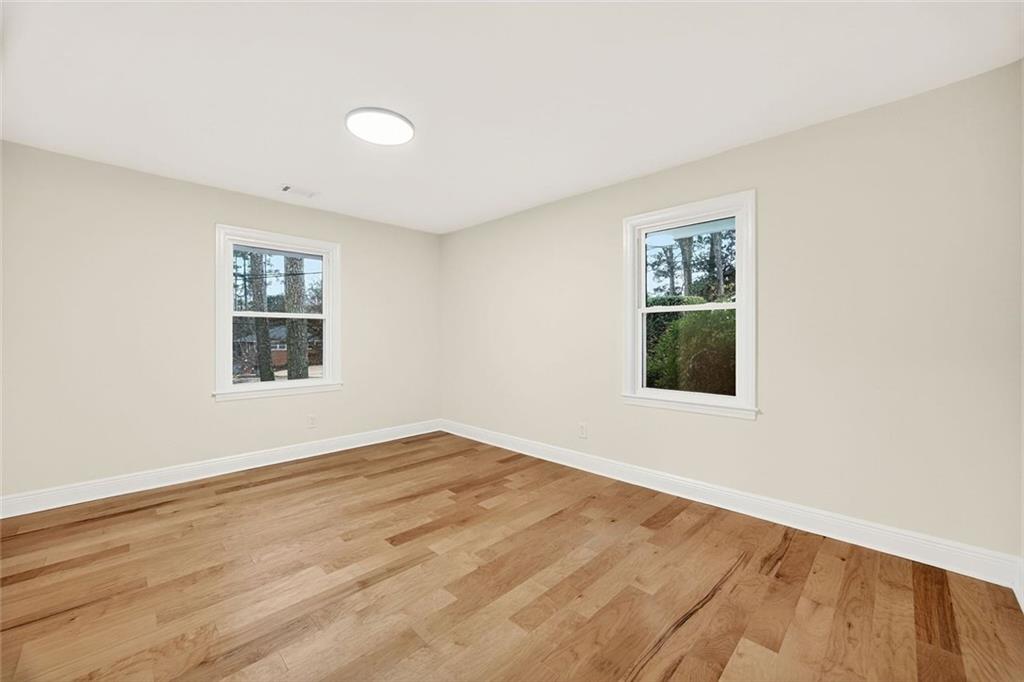 3365 Ardley Road Southwest Atlanta, GA 30311 - Photo 23 of 34 a view of an empty room with wooden floor and a window