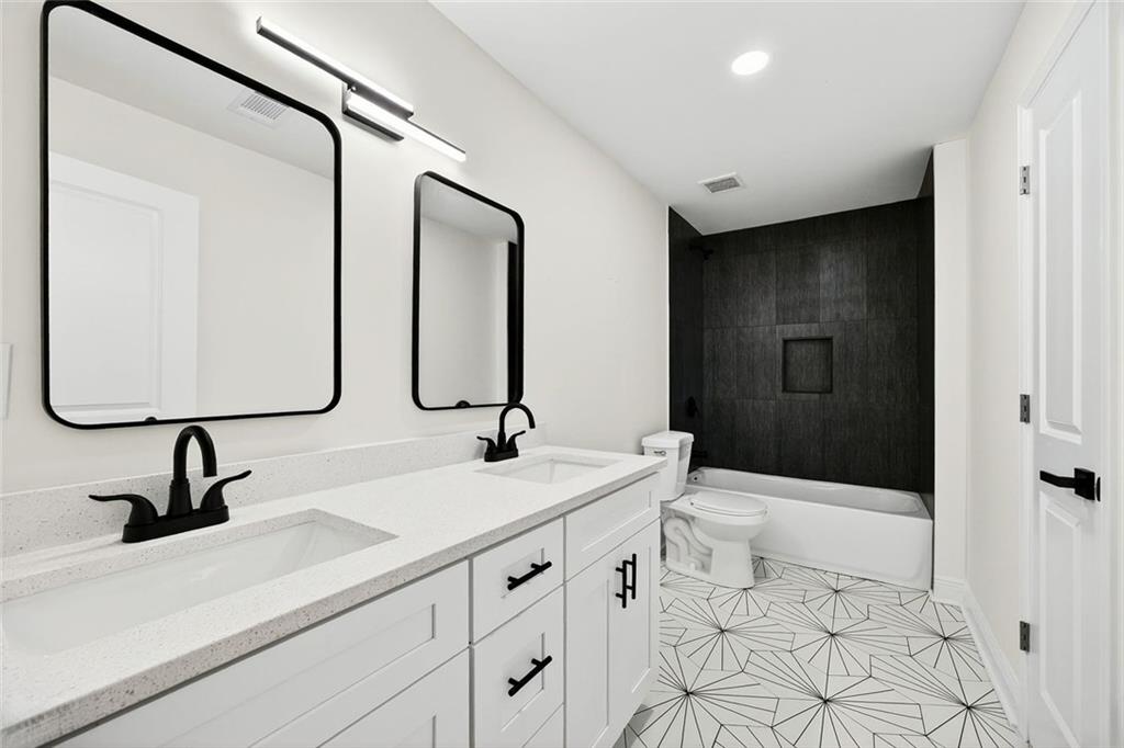 3365 Ardley Road Southwest Atlanta, GA 30311 - Photo 24 of 34 a bathroom with a sink and mirror