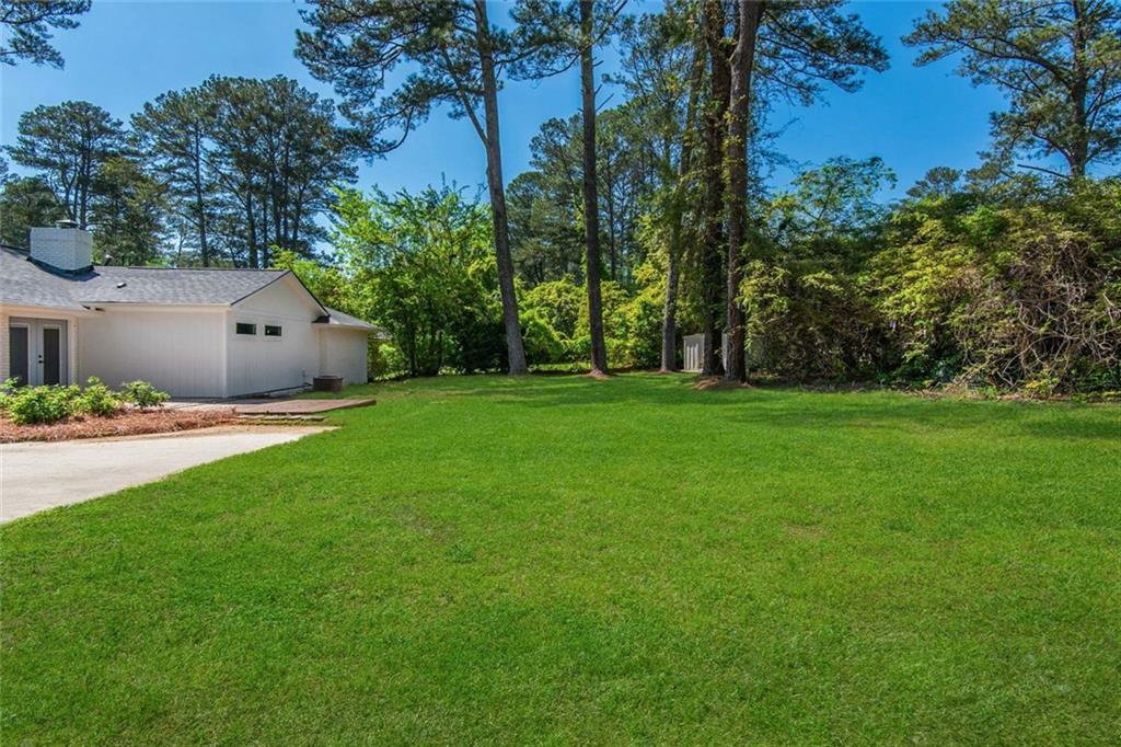 3365 Ardley Road Southwest Atlanta, GA 30311 - Photo 33 of 34 a front view of a house with a garden and yard