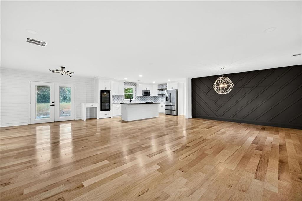3365 Ardley Road Southwest Atlanta, GA 30311 - Photo 5 of 34 a view of kitchen and empty room with wooden floor