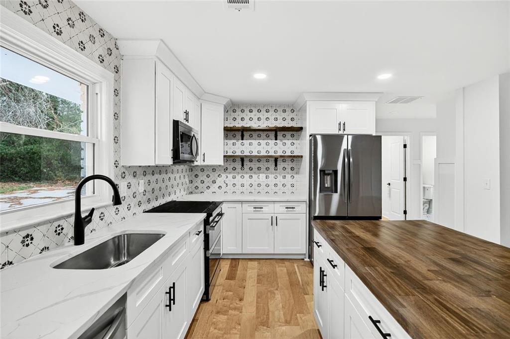3365 Ardley Road Southwest Atlanta, GA 30311 - Photo 8 of 34 a kitchen with a refrigerator sink and cabinets