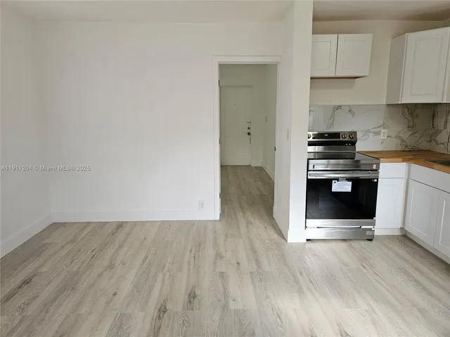 a kitchen with wooden floors and a stove