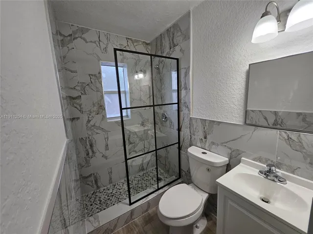 a white toilet sitting next to a bathroom sink