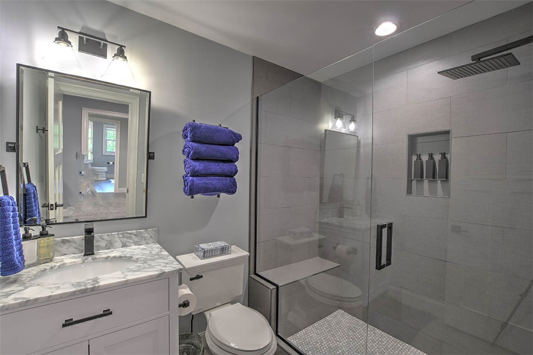 6323 Autumn Ridge Court Decatur, IL 62521 - Photo 25 of 43 a bathroom with a granite countertop sink a toilet and shower
