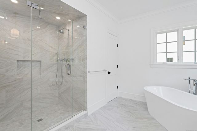 a bathroom with a bathtub and a shower