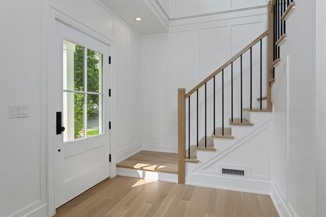 a view of an entryway with wooden floor and door