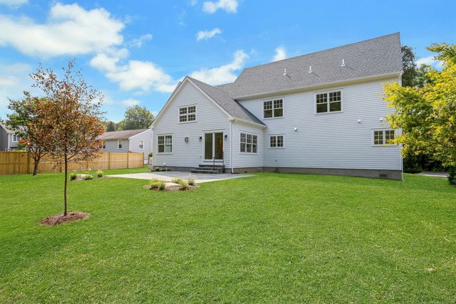a view of a house with a backyard porch and sitting area