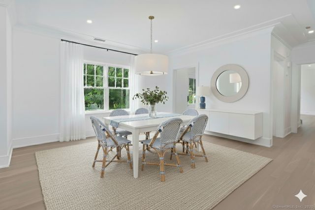 a dining room with furniture a chandelier and a rug