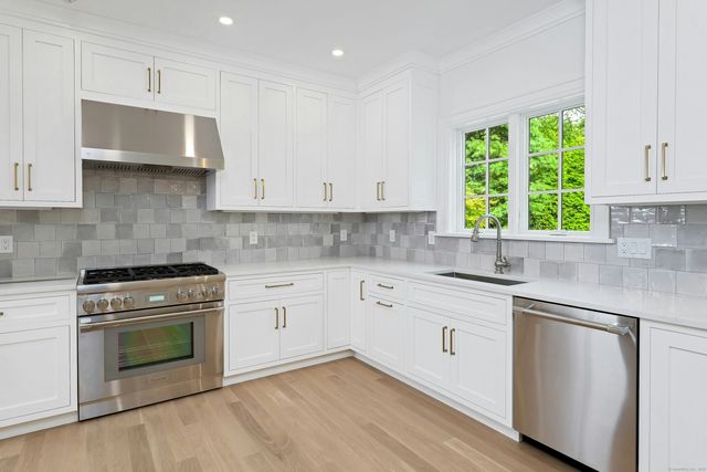 a kitchen with appliances cabinets and a sink