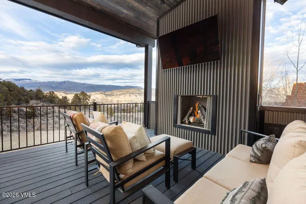 a view of a roof deck with wooden floor and city view