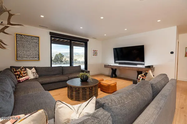 a living room with furniture and a view of kitchen