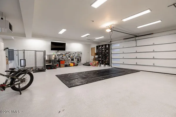 a view of kitchen with stainless steel appliances kitchen island wooden floor and window