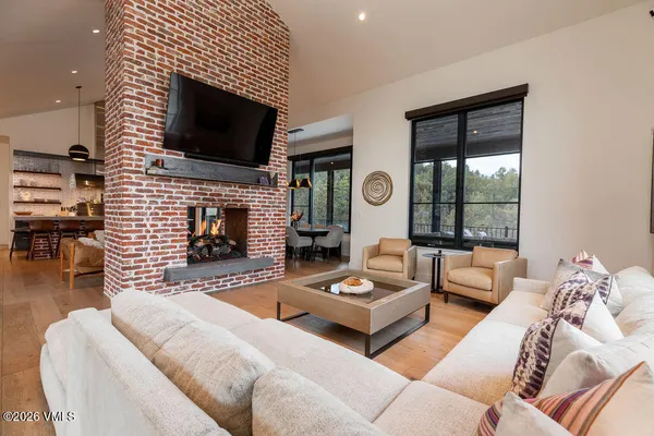 a living room with fireplace furniture and a flat screen tv