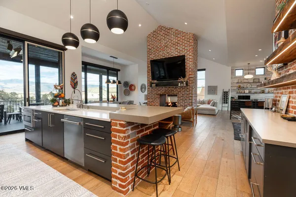 a kitchen with a table chairs and chandelier