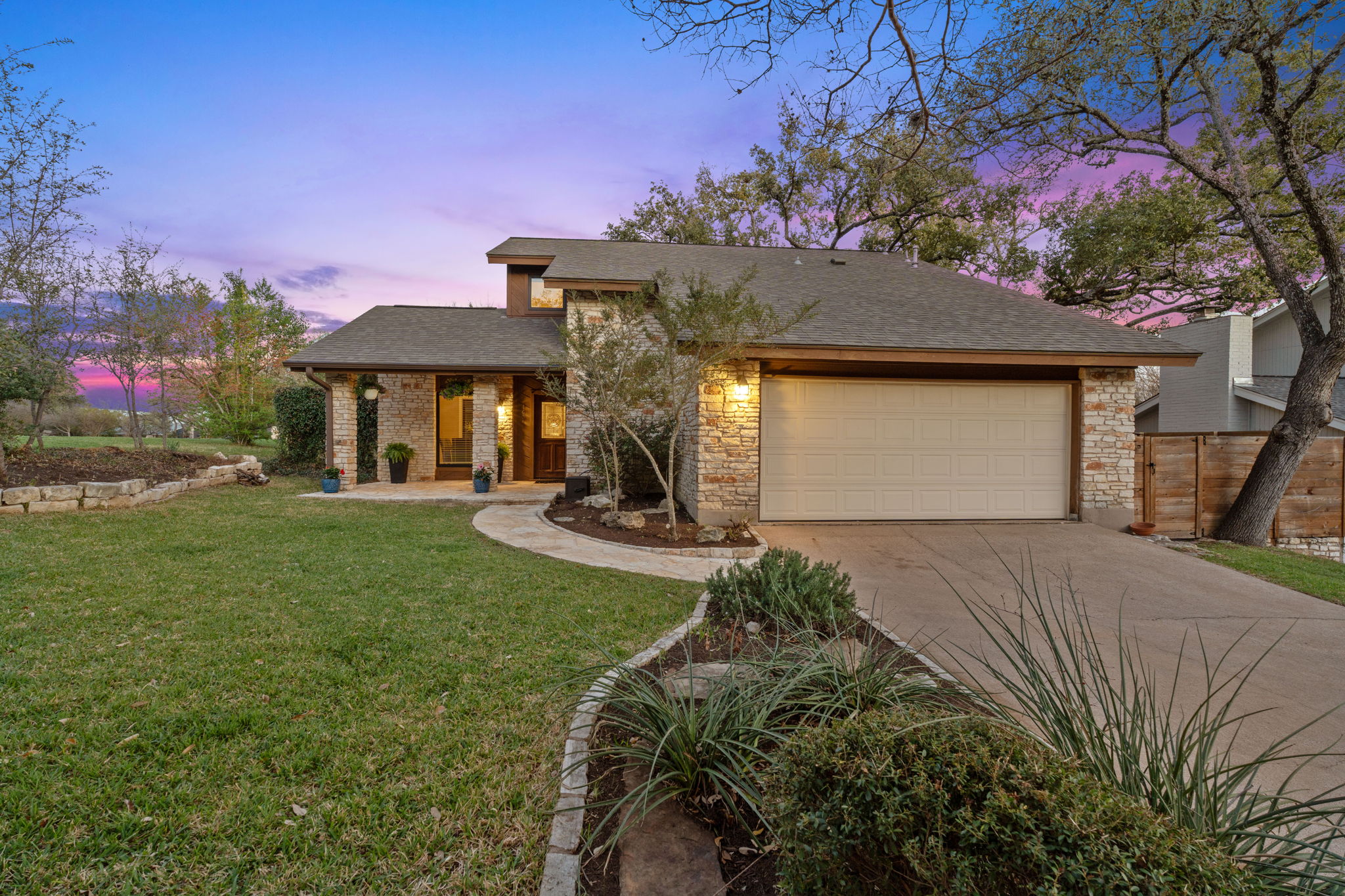 4601 Creek Ridge Austin, TX 78735 - Photo 1 of 40 View of front of home with a shingled roof, driveway, a porch, and a garage