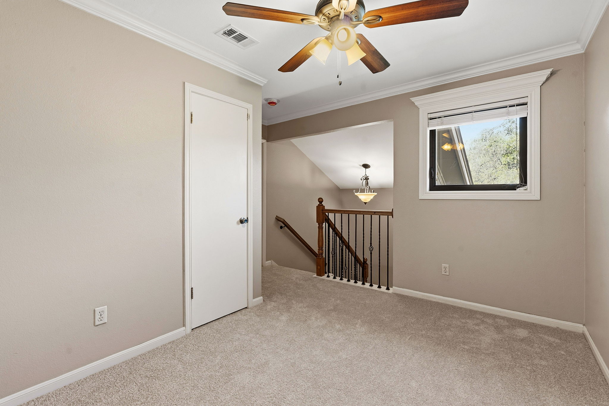 4601 Creek Ridge Austin, TX 78735 - Photo 15 of 40 Spare room featuring crown molding, light colored carpet, and ceiling fan
