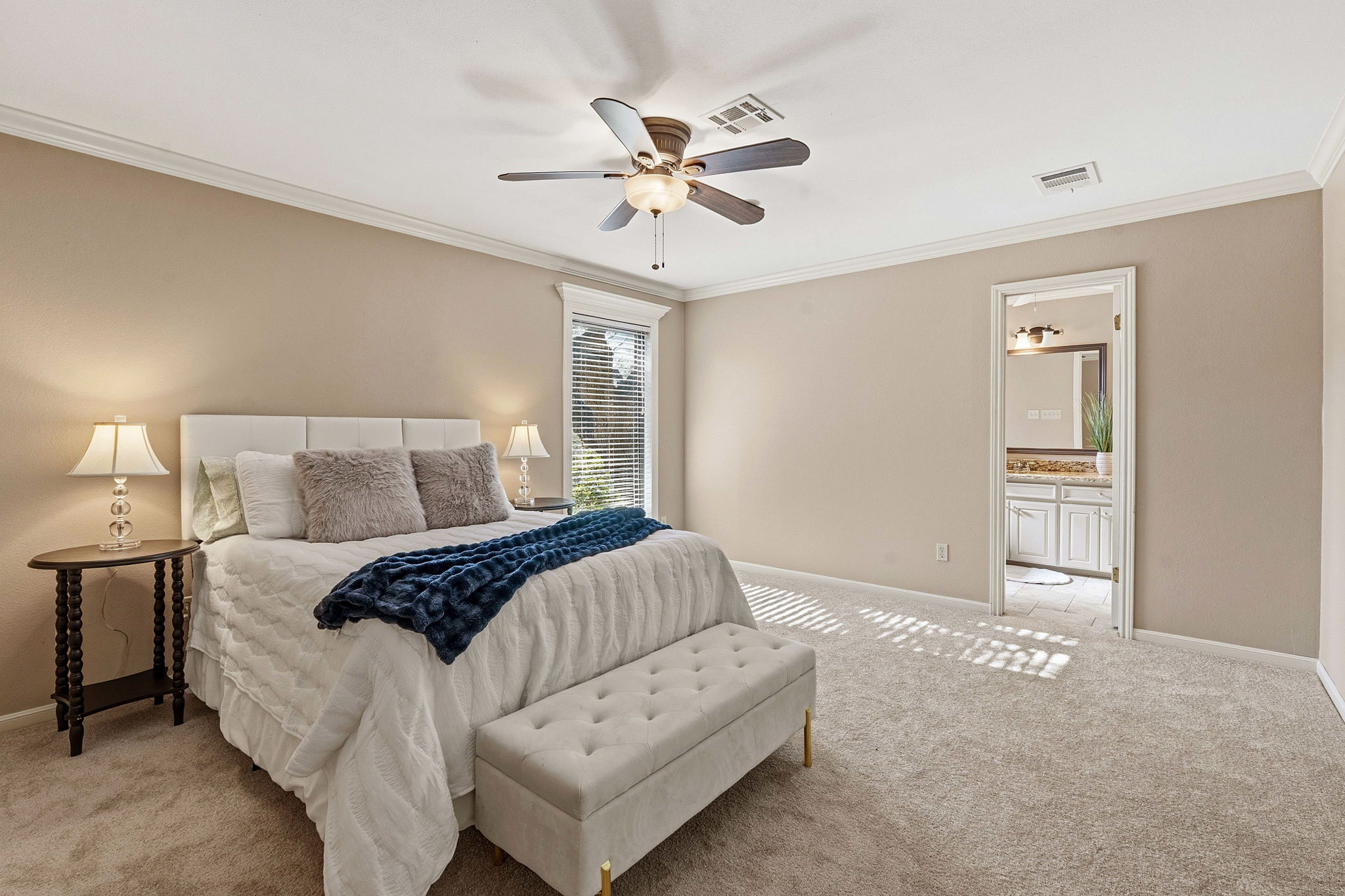 4601 Creek Ridge Austin, TX 78735 - Photo 16 of 40 Bedroom with ornamental molding, light colored carpet, a ceiling fan, and ensuite bathroom