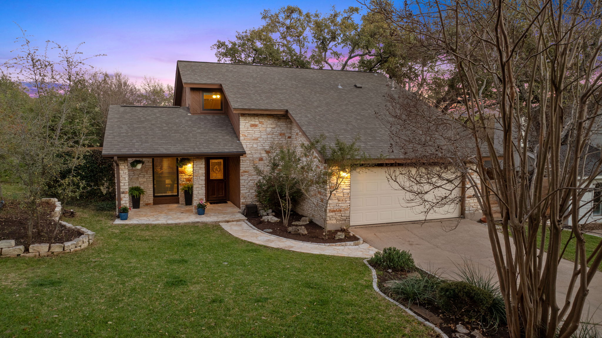 4601 Creek Ridge Austin, TX 78735 - Photo 2 of 40 Mid-century home featuring a front yard, concrete driveway, a garage, and a shingled roof