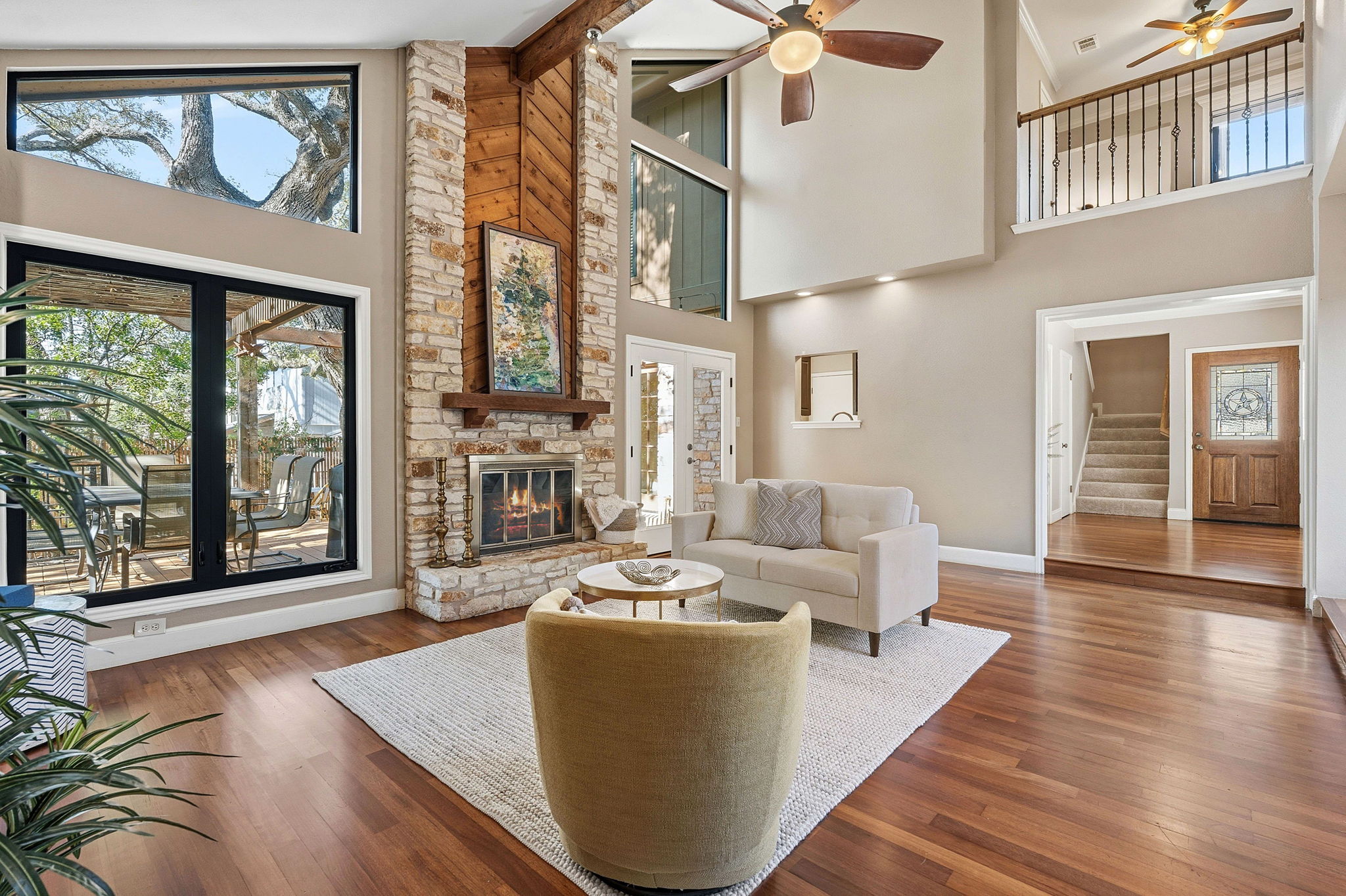 4601 Creek Ridge Austin, TX 78735 - Photo 6 of 40 Living area with ceiling fan, hardwood / wood-style flooring, a fireplace, and healthy amount of natural light