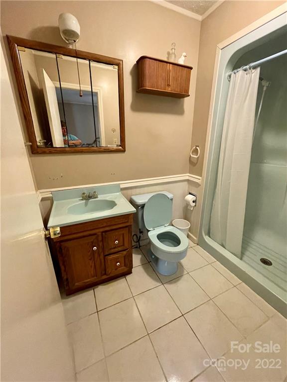 911 Long Branch Road Grover, NC 28073 - Photo 13 of 37 a bathroom with a sink a mirror and a shower