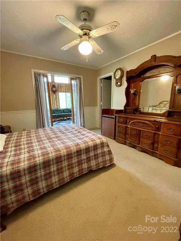 911 Long Branch Road Grover, NC 28073 - Photo 15 of 37 a bedroom with a large bed and a chandelier