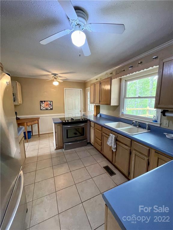 911 Long Branch Road Grover, NC 28073 - Photo 18 of 37 a kitchen with stainless steel appliances granite countertop a sink counter space cabinets and a window