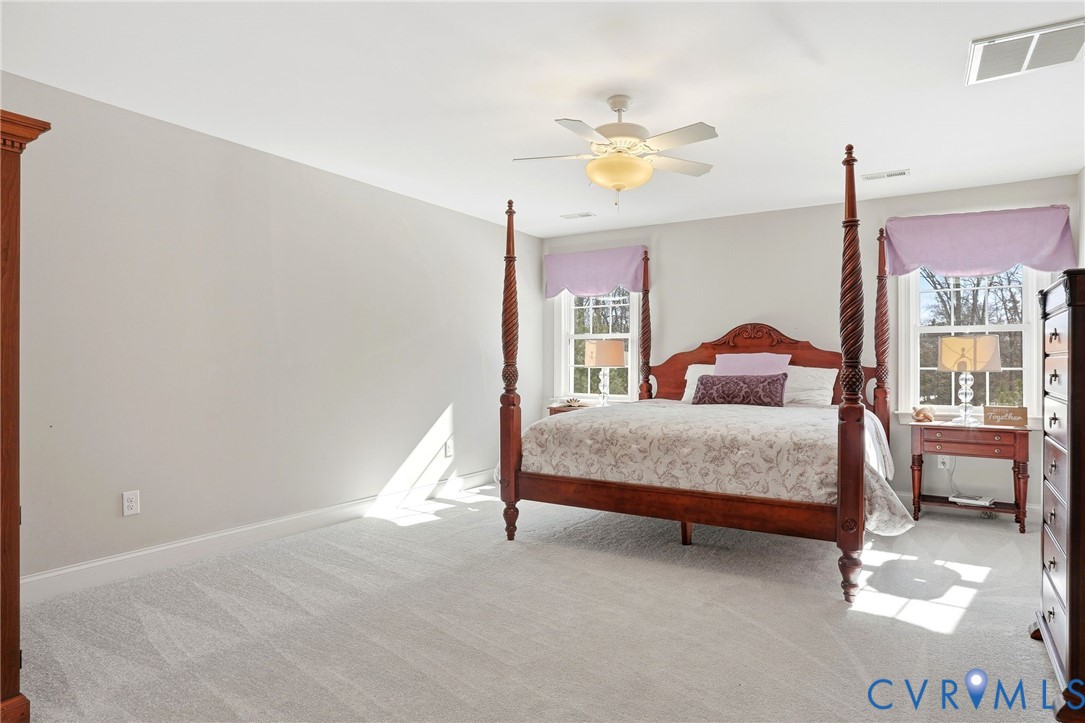 12050 Cameron Creek Road Glen Allen, VA 23059 - Photo 16 of 36 a bedroom with a bed and a chandelier