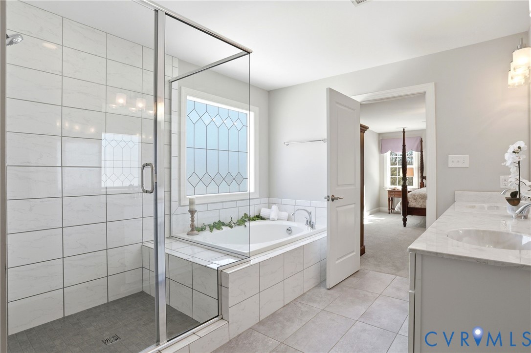 12050 Cameron Creek Road Glen Allen, VA 23059 - Photo 18 of 36 a bathroom with a tub a sink and a mirror